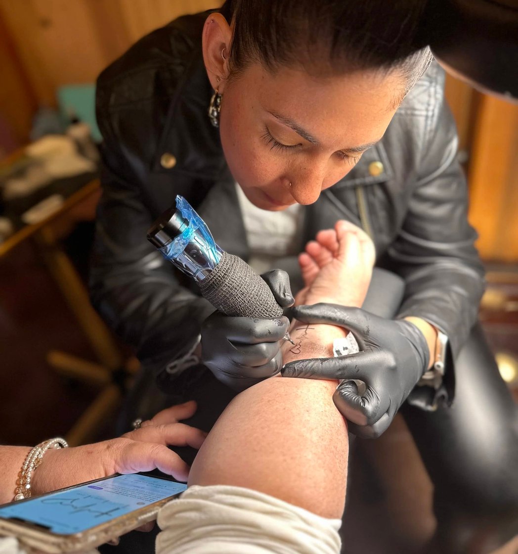 Artist performing cosmetic tattooing at Picosa Ink Beauty Bar