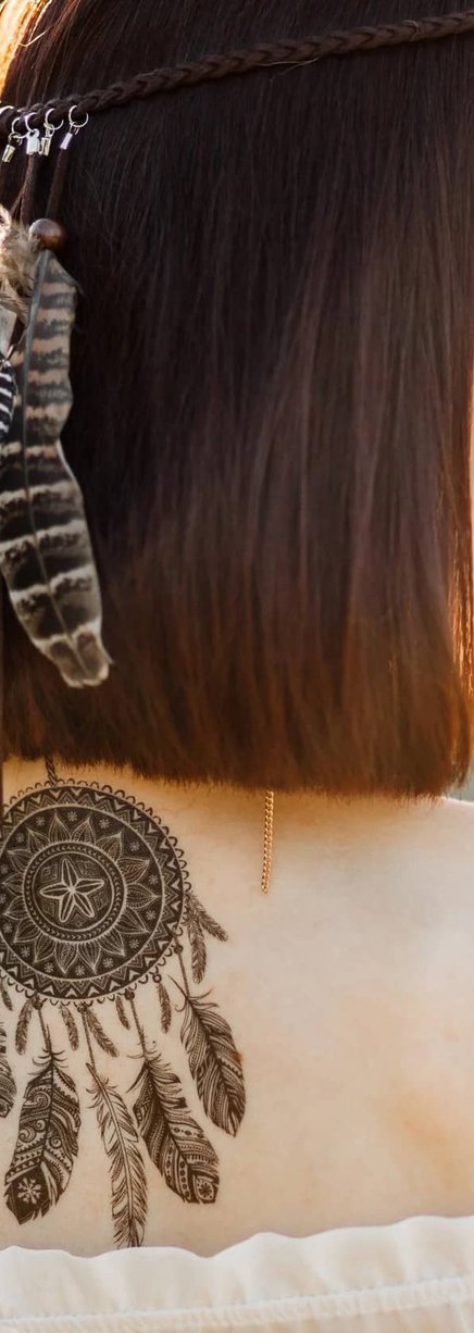 Woman showing healed shoulder tattoo